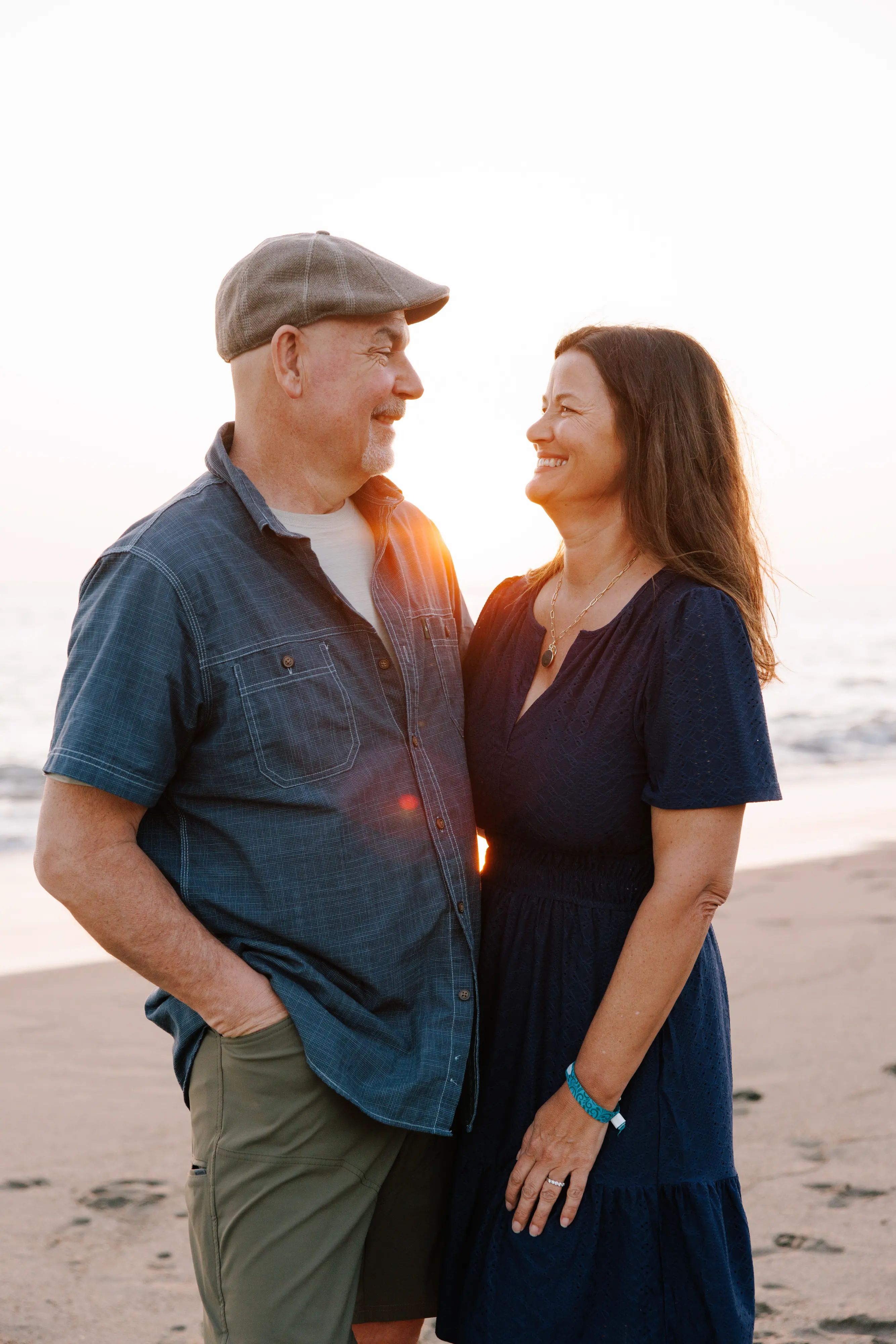 Family of four beach portrait session in Puerto Vallarta with Banderas Bay mountains behind