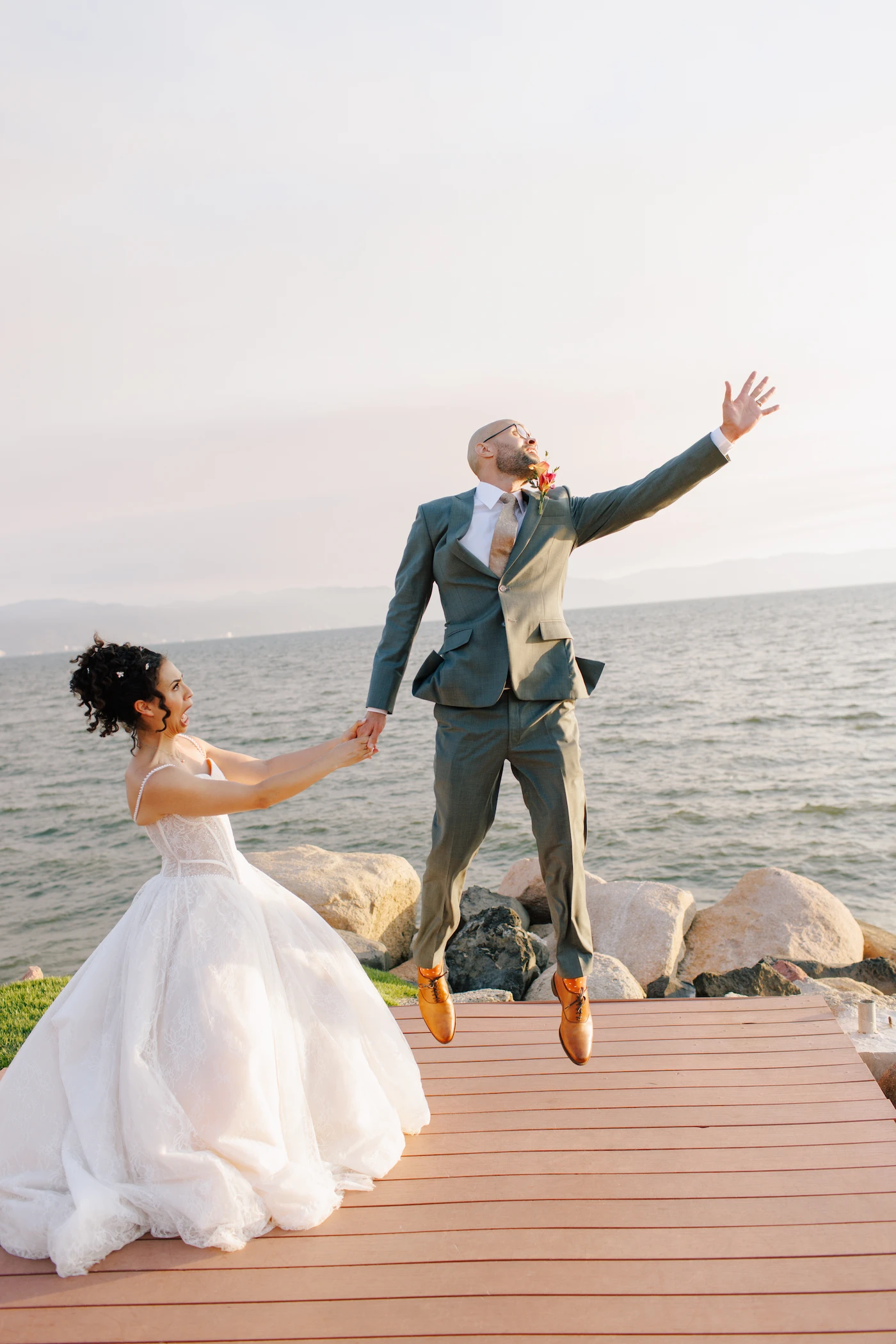 Liz and Julian celebrating on the waterfront dock at Velas Puerto Vallarta wedding