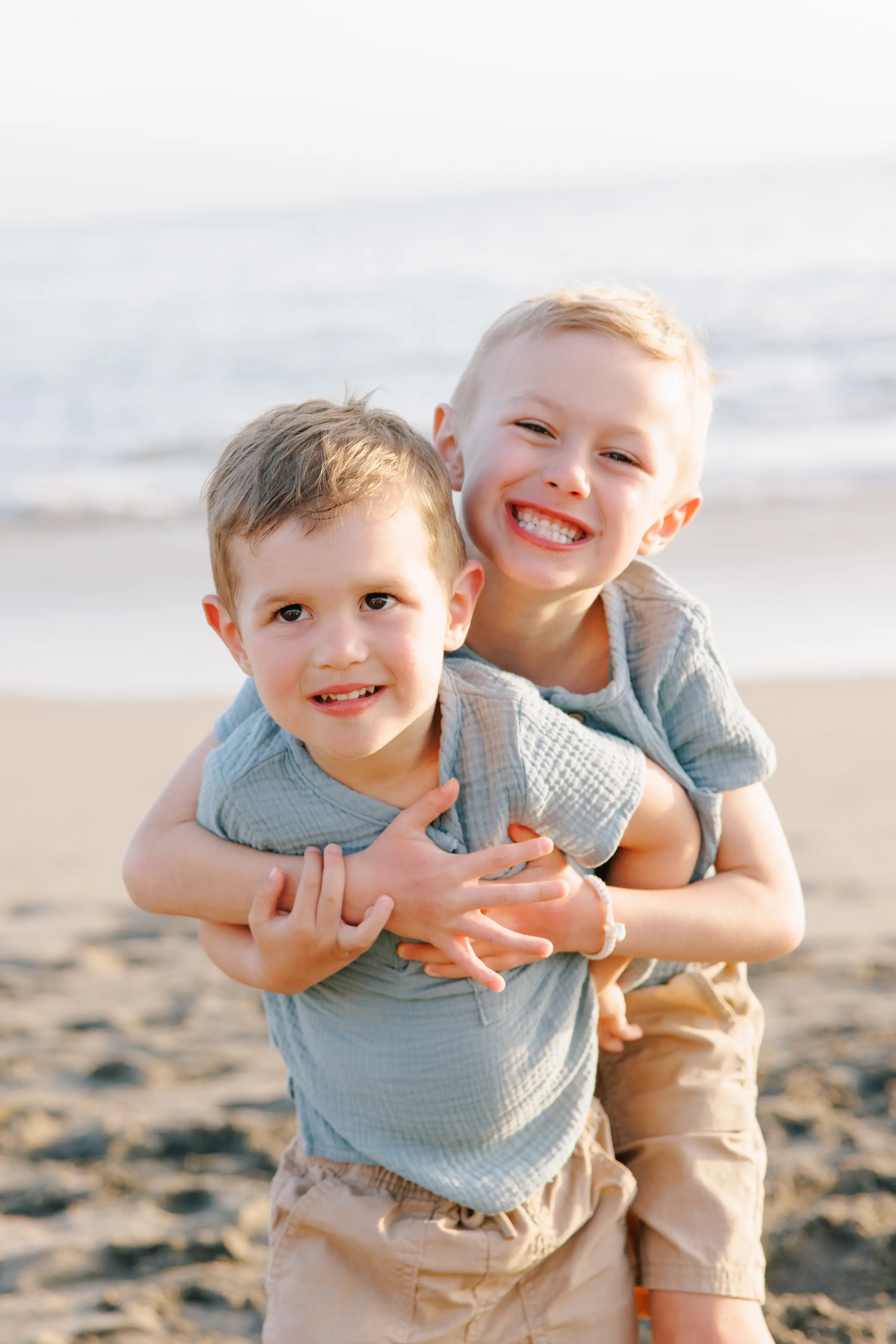 Two brothers hugging at golden hour during family photography session in Puerto Vallarta