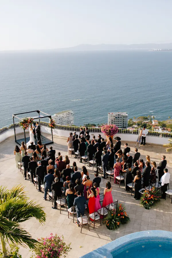 Couple's first kiss at an outdoor ceremony overlooking Banderas Bay, Puerto Vallarta